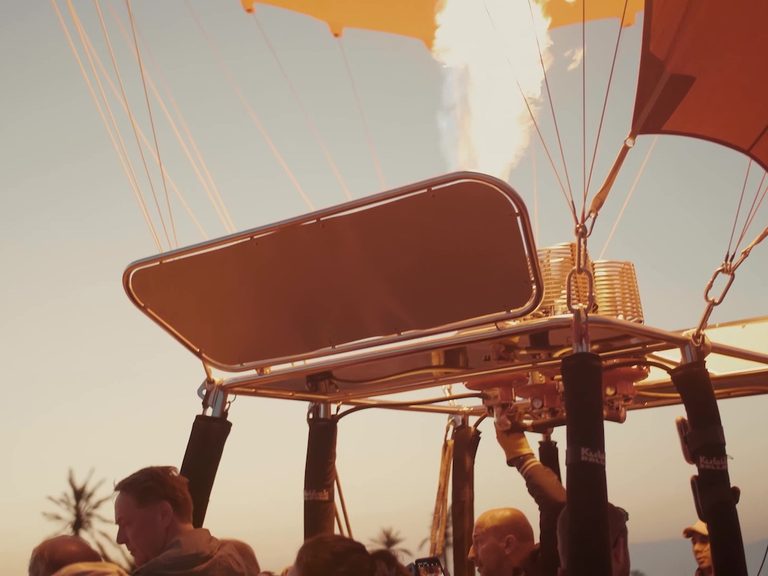 Burners and rigging above a balloon basket with passengers below